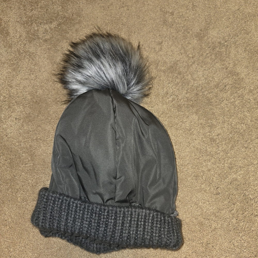 Grey Pom-Pom Beanie With A Fleece Lining.